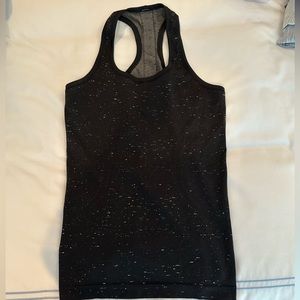 Like new. Lulu lemon swiftly tank in black speckle.